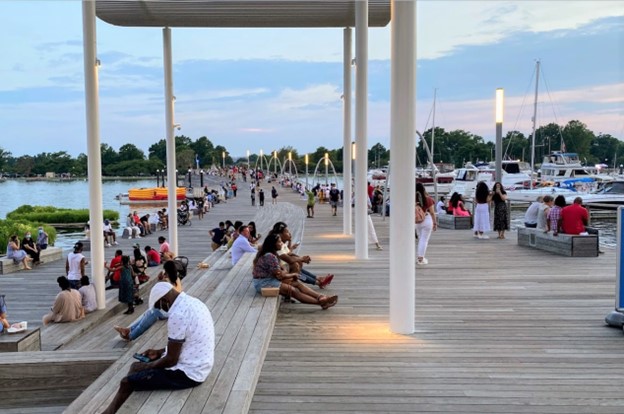 groups of people outside on pier at the wharf on a sunny day