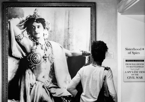 Visitor at the Spy Museum looking at a portrait of Mata Hari